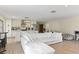 Open concept living room and kitchen with white sectional sofa and hardwood floors at 4041 Yacht Ct, Winter Park, FL 32792