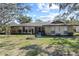 Ranch style home with stone facade and landscaped lawn at 4041 Yacht Ct, Winter Park, FL 32792