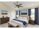 Comfortable bedroom with king-size bed, wooden accents, and blue curtains at 2111 Turnberry Dr, Oviedo, FL 32765