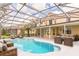 Inviting pool area with screened enclosure and comfortable seating at 2111 Turnberry Dr, Oviedo, FL 32765