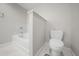 Bathroom with a bathtub and toilet, separated by a half wall at 16300 County Road 455 # 103, Montverde, FL 34756