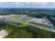 Aerial view of community featuring a lake, pool, and townhomes at 5043 Prairie Preserve Run, St Cloud, FL 34772