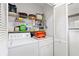 Practical laundry room with washer, dryer, and shelving for storage at 466 Bouchelle Dr # 202, New Smyrna Beach, FL 32169