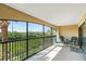 Spacious screened balcony overlooking lush landscape at 466 Bouchelle Dr # 202, New Smyrna Beach, FL 32169