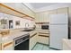 Efficient kitchen with ample cabinetry and modern appliances at 466 Bouchelle Dr # 202, New Smyrna Beach, FL 32169