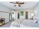 Bright bedroom with a comfortable bed and ceiling fan at 466 Bouchelle Dr # 202, New Smyrna Beach, FL 32169