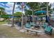 Community seating area with fire pit and shade structures at 466 Bouchelle Dr # 202, New Smyrna Beach, FL 32169