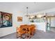 Bright dining area with wood table and orange chairs, adjacent to kitchen at 466 Bouchelle Dr # 202, New Smyrna Beach, FL 32169