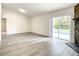 Bright living room with fireplace, sliding glass doors to pool, and wood-look floors at 3130 Willow Oak Dr, Edgewater, FL 32141