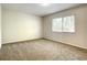 Well-lit bedroom with large window and carpeted floors at 3130 Willow Oak Dr, Edgewater, FL 32141