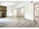 Spacious living area with wood-look flooring and a stone fireplace at 3130 Willow Oak Dr, Edgewater, FL 32141