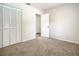 Bright bedroom with neutral walls and carpet, featuring a double door closet and access to another room at 3130 Willow Oak Dr, Edgewater, FL 32141