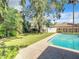 Landscaped backyard with lush greenery and a swimming pool at 3130 Willow Oak Dr, Edgewater, FL 32141
