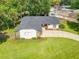 Single-story home with a dark roof, driveway, and spacious lawn at 3130 Willow Oak Dr, Edgewater, FL 32141