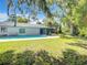 Spacious backyard with a refreshing pool and lush green grass at 3130 Willow Oak Dr, Edgewater, FL 32141
