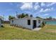 White house with black door and landscaping at 25 River Dr, Ormond Beach, FL 32176