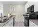 Modern kitchen with stainless steel appliances and gray countertops at 770 Pebble Beach Dr, Davenport, FL 33896