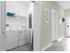 Bright laundry room with washer, dryer, and additional storage at 770 Pebble Beach Dr, Davenport, FL 33896