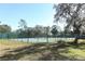 Well-maintained tennis court with perimeter fence at 259 New Waterford Pl, Longwood, FL 32779