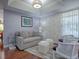 Cozy living room with hardwood floors, neutral-toned furniture, and wall art at 259 New Waterford Pl, Longwood, FL 32779