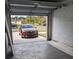 Garage with open door, showing a car and driveway at 776 E Broadway St, Oviedo, FL 32765
