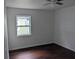 Bright bedroom with wood-look floors and a window at 776 E Broadway St, Oviedo, FL 32765
