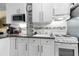 Small kitchen with white cabinets and granite countertops at 701 S Atlantic Ave # 508, Daytona Beach, FL 32118