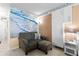 Living room with sofa, ottoman, and ocean-themed wall art at 701 S Atlantic Ave # 508, Daytona Beach, FL 32118