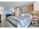 Bedroom with king bed, ocean mural, and sitting area at 701 S Atlantic Ave # 508, Daytona Beach, FL 32118