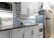 Small kitchen with white cabinets and granite countertops at 701 S Atlantic Ave # 508, Daytona Beach, FL 32118