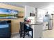 Small kitchen with white cabinets, granite counters, and breakfast bar at 701 S Atlantic Ave # 508, Daytona Beach, FL 32118