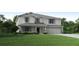 Two story house with a two car garage and manicured lawn at 2223 Elegant Manor Cir, Edgewater, FL 32141