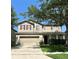 Two story house with tan siding and maroon shutters at 1769 Morning Sky Dr, Winter Garden, FL 34787