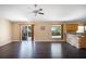 Gathering room featuring dark hardwood floors, stone accent wall, and kitchen access at 221 Rosa Ave, Oviedo, FL 32765
