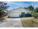 One-story house with attached garage and landscaped front yard at 221 Rosa Ave, Oviedo, FL 32765