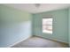 Simple bedroom with light walls, carpet, and a window at 221 Rosa Ave, Oviedo, FL 32765