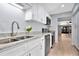 Updated kitchen features granite countertops, stainless steel appliances, and white cabinets at 2205 Cypress Cove Dr, Tavares, FL 32778
