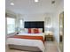 Main bedroom with king-size bed, dark headboard, and wood nightstand at 3004 Red Ginger Rd, Kissimmee, FL 34747