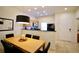 Dining area with wooden table, black chairs, and kitchen view at 3004 Red Ginger Rd, Kissimmee, FL 34747
