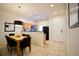Dining area with wooden table, black chairs, and kitchen view at 3004 Red Ginger Rd, Kissimmee, FL 34747