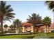 Community clubhouse with landscaping and palm trees at 3004 Red Ginger Rd, Kissimmee, FL 34747