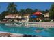 Community pool with lounge chairs and a playground at 3004 Red Ginger Rd, Kissimmee, FL 34747