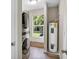 Laundry room with stacked washer and dryer and window at 10 Locust Run Crse, Ocala, FL 34472