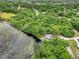 House nestled in lush greenery near a serene lake at 10 Locust Run Crse, Ocala, FL 34472