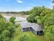 Aerial view of a charming ranch house with a pond in the backyard at 10 Locust Run Crse, Ocala, FL 34472