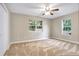 Spacious bedroom with neutral walls, ceiling fan, and plush carpeting at 10 Locust Run Crse, Ocala, FL 34472