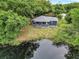 House nestled in lush greenery near a serene lake at 10 Locust Run Crse, Ocala, FL 34472