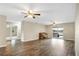 Large living room with wood flooring, ceiling fan, and access to deck at 10 Locust Run Crse, Ocala, FL 34472