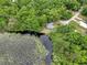 House nestled in lush greenery near a serene lake at 10 Locust Run Crse, Ocala, FL 34472