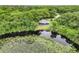 House nestled in lush greenery near a serene lake at 10 Locust Run Crse, Ocala, FL 34472